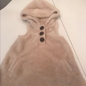 A warm  cream color vest with a hood